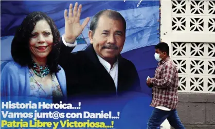  ?? ?? A man walks past a banner depicting Rosario Murillo and Daniel Ortega in Managua. Photograph: Reuters