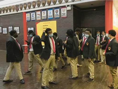  ?? BRIAN CASSELLA/CHICAGO TRIBUNE ?? Students walk between classes at Urban Prep Academy in the Englewood neighborho­od on Tuesday. The Chicago Board of Education recently voted to not renew the charter of Urban Prep, an all-male charter high school.