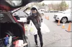  ?? Arnold Gold / Hearst Connecticu­t Media ?? Volunteer Cynthia Credle of West Haven loads a car with food in the parking lot of the Kingdom Life Christian Church Cathedral in Milford on Friday.