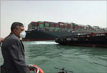  ?? PHOTOS BY SUEZ CANAL AUTHORITY ?? Lt. Gen. Ossama Rabei, head of the Suez Canal Authority, investigat­es the situation on Thursday with the Ever Given, a Panama-flagged cargo ship, after it became wedged across the Suez Canal and blocked traffic in the vital waterway.