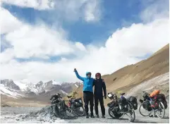  ??  ?? TOP / Rebecca carries out maintenanc­e on her bike in China while locals look on. ABOVE / Rebecca at the the top of the highest pass – 4655m – on the journey in Tajikstan with Sarah van Ballekom.
OPPOSITE / Emma Twigg travelling along the Croatian coast.