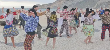  ?? RICK STEVES ?? Down along the beach, local folk music groups dance proudly for visitors to Nazare, a fishing town situated two hours north of Lisbon.