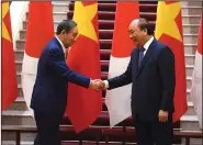  ?? (AP/Nhac Nguyen) ?? Japanese Prime Minister Yoshihide Suga (left) and Vietnamese counterpar­t Nguyen Xuan Phuc meet Monday at the Government Office in Hanoi, Vietnam. More photos at arkansason­line.com/1020pm/.