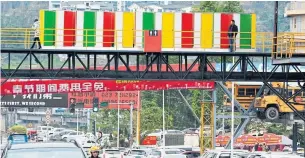  ?? AFP/GETTY IMAGES ?? A public toilet is located on a pedestrian bridge in Chongqing, China. Pristine public washrooms are becoming a leading economic indicator of progress in the world’s second-largest economy.