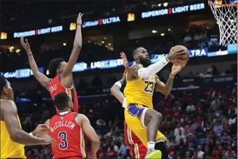  ?? GERALD HERBERT — THE ASSOCIATED PRESS ?? Los Angeles Lakers forward LeBron James (23) goes to the basket in the first half of an NBA basketball play-in tournament game against the New Orleans Pelicans, Tuesday, April 16, 2024, in New Orleans.