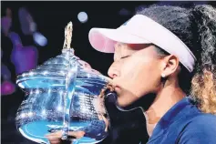  ??  ?? File photo shows Japan’s Naomi Osaka kisses her trophy after winning her match against Czech Republic’s Petra Kvitova. — Reuters photo