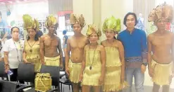  ?? ?? Decked out in tribal finery, indigenous performers pose for a souvenir shot for the urban yokels.