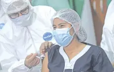  ?? — AFP photo ?? A medical worker is inoculated with Russia’s Sputnik V vaccine against the coronaviru­s disease at the Hospital Japones (Japanese Hospital) in Santa Cruz, Bolivia.