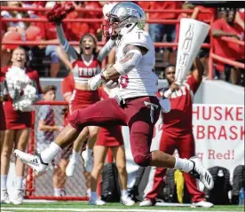  ?? STEVEN BRANSCOMBE / GETTY IMAGES ?? Troy running back B.J. Smith runs in one of his two touchdowns Saturday against Nebraska, which has lost six straight home games.