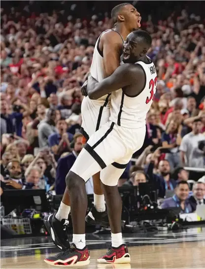  ?? DAVID J. PHILLIP/AP ?? San Diego State guard Lamont Butler leaps into the arms of teammate Aguek Arop after draining his buzzer-beater.