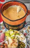  ?? CHRIS HUNT FOR THE AJC ?? Classic cheese fondue can be served with sliced apples, bread, gherkins and pickled onions, but possible pairings are limited only by imaginatio­n.