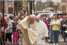  ?? RICK KAUFFMAN — DIGITAL FIRST MEDIA ?? Rev. Edward H. Bell of the Nativity of the Blessed Virgin Mary carried the cross through the streets of Media on Friday.