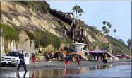  ?? DENIS POROY — THE ASSOCIATED PRESS ?? Search and rescue personnel work at the site of a cliff collapse at a popular beach Friday, Aug. 2. in Encinitas, Calif. At least one person was reportedly killed, and multiple people were injured, when an oceanfront bluff collapsed Friday at Grandview Beach in the Leucadia area of Encinitas, authoritie­s said.