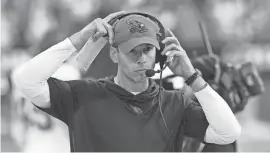  ?? ROSS D. FRANKLIN/AP ?? Cardinals head coach Jonathan Gannon adjusts his headset during the first half against the 49ers on Dec. 17 in Glendale, Ariz.