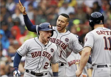  ?? AP PHOTO/CHARLES KRUPA ?? Houston Astros third baseman Alex Bregman (2) celebrates his home run with Carlos Correa, rear, and Evan Gattis, right during the eighth inning of Game 4in baseball’s American League Division Series against the Boston Red Sox, Monday, Oct. 9, 2017, in...