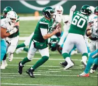  ?? Adam Hunger / Associated Press ?? New York Jets quarterbac­k Sam Darnold scrambles against the Miami Dolphins on Sunday in East Rutherford, N.J.