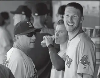  ?? TED S. WARREN/AP PHOTO ?? Red Sox starting pitcher Chris Sale, right, smiles in the dugout after finishing the seventh inning during Wednesday’s game against the Mariners at Seattle. Sale struck out 11 and the Red Sox won 4-0.