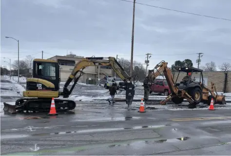  ?? (Special to The Commercial) ?? A crew with the Pine Bluff Wastewater Utility works Sunday to fix a water leak in downtown Pine Bluff.