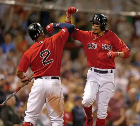  ?? STUART CAHILL / BOSTON HERALD ?? PUMP IT UP: Mookie Betts celebrates with Xander Bogaerts after hitting a homer in the eighth inning.