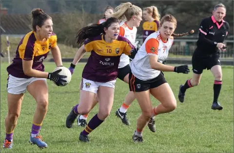  ??  ?? Aisling Murphy on the move for Wexford, with Holly Hynes in support, as Armagh’s Aveen Donaldson tries to track her run.