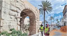  ??  ?? LABOURERS walk past the Roman Marcus Aurelius arch in the Libyan capital Tripoli’s old city. | AFP