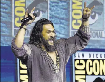  ?? Chris Pizzello The Associated Press ?? A giddy Jason Momoa greets the crowd at the Warner Bros. Theatrical panel for “Aquaman” on day three of Comic-Con Internatio­nal on Saturday in San Diego.