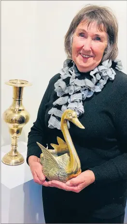  ??  ?? TREASURES: swans.
Collector Joy Bryce with one of her favorite brass