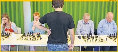 ?? PHOTO: JW3 ?? Etan Ilfeld ( centre) ponders his next move during a simultaneo­us chess event which saw 20 players pit their wits against the London-based grandmaste­r. It was the precursor to the Mind Sport Olympiad at the JW3 cultural centre
