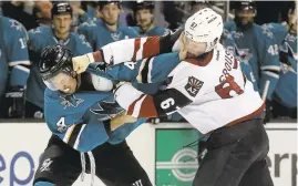  ?? JEFF CHIU/ASSOCIATED PRESS ?? The Sharks’ Brenden Dillon (4) fights the Coyotes’ Lawson Crouse earlier this month.
