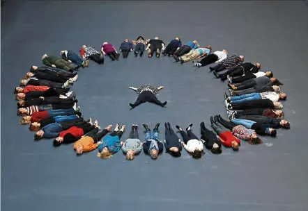  ??  ?? Bruguera lies down in the middle of her Hyundai Commission artwork Our Neighbours in the the Turbine Hall of Tate Modern in London. The installati­on on the theme of migration sees viewers use their body heat to make a portrait of a young Syrian refugee appear on the floor. — Photos: Reuters