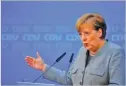  ??  ?? HANNIBAL HANSCHKE/REUTERS Acting German Chancellor Angela Merkel addresses a news conference at the Christian Democratic Union (CDU) party headquarte­rs in Berlin, Germany, on December 18, 2017.