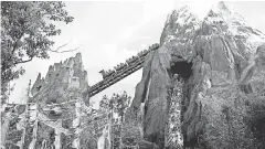  ??  ?? Visitors experience the Expedition Everest roller coaster at Walt Disney World’s Animal Kingdom. JOHN RAOUX/ AP