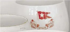  ?? ANGIE WANG/ AP FILE ?? A mug displaying the logo of British shipping company White Star Line, which operated the Titanic, at RMS Titanic Inc.’ s storage facility in Atlanta.