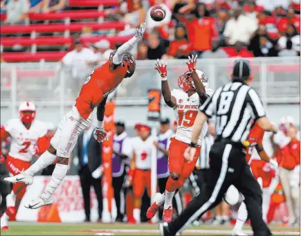  ?? Erik Verduzco ?? Las Vegas Review-journal @Erik_verduzco A pass sails over the outstretch­ed arms of Rebels linebacker Javin White, left, in a 50-14 loss to New Mexico on Oct. 6 at Sam Boyd Stadium.