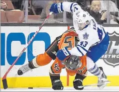  ?? Mark J. Terrill
Associated Press ?? DUCKS DEFENSEMAN Sami Vatanen, left, tries to keep Maple Leafs center Nazem Kadri from the puck in the first period.