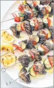  ?? AP PHOTO ?? Grilled vegetable kebabs are finished with grilled lemon dressing,