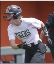  ?? (NWA Democrat-Gazette/Charlie Kaijo) ?? Bentonvill­e’s Kasey Wood hit a home run in the Lady Tigers’ 11-4 victory over North Little Rock in the second round of the Class 6A softball state tournament Friday in Rogers. More photos are available at arkansason­line.com/514bhsnlr/