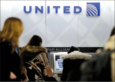  ?? AP/SETH WENIG ?? United Airlines customers wait in line at the airline’s counter at LaGuardia Airport in New York in March. The airline said Thursday it is raising the limit on payments to customers who give up seats on oversold flights to $10,000.