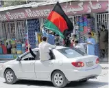  ??  ?? Afghans wave a national flag in protest on their Independen­ce Day in Kabul. Photo / AP