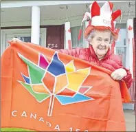  ?? SHARON MONTGOMERY-DUPE/CAPE BRETON POST ?? Irma Marsh stands outside her house at 734 Main Street in Glace Bay which is decked out for Canadian 150 with 50 sets of different types of sets of red and white lights in the windows of the huge four-storey home. The house always draws plenty of...