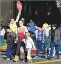  ?? FREDERIC J. BROWN AFP via Getty Images ?? A CROSSING GUARD after school at Ramona Elementary in Alhambra.