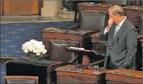  ?? AP/Senate Television ?? Sen. Lindsey Graham, R-S.C., pauses Tuesday during a tribute on the Senate floor to his close friend, the late Sen. John McCain, whose desk is draped in black with a bouquet sitting on it. “It is going to be a lonely journey for me for a while,” Graham said while fighting back tears, reading from handwritte­n notes. “The void to be filled by John’s passing is more than I can fill. Don’t look to me to replace this man,” Graham said.