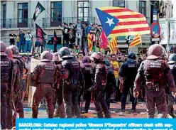  ?? —AFP ?? BARCELONA: Catalan regional police ‘Mossos D’Esquadra’ officers clash with separatist protesters during a counter-protest against a demonstrat­ion in support of Spanish police in Barcelona yesterday.