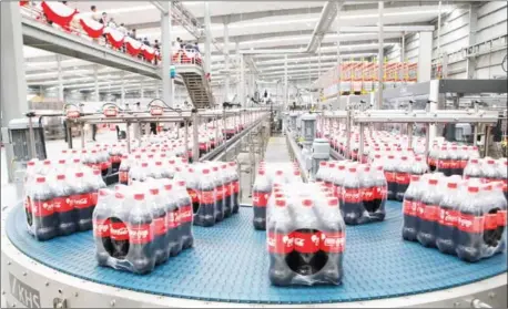  ?? PHA LINA ?? Hundreds of bottles of Coca-Cola are ready to be distribute­d from the company’s new factory in Phnom Penh’s Special Economic Zone. The factory was formally opened yesterday.