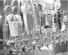  ?? Michael Ciaglo / Houston Chronicle ?? The beer taps are all lined up as employees prepare the new Ginger Man in Midtown for its opening this week.