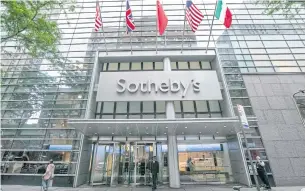  ?? AP ?? Flags fly on the front of Sotheby’s auction house in New York on Monday.