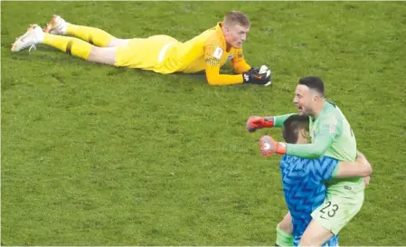  ?? AP ?? Croatia goalkeeper Danijel Subasic celebrates with a teammate as England goalkeeper Jordan Pickford lies on the ground in disappoint­ment.