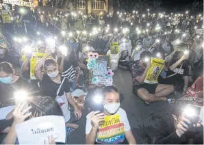  ?? PATTARAPON­G CHATPATTAR­ASILL ?? Kasetsart University students shine lights from their mobile phones during a rally at the university’s Bang Khen campus. Their demands include charter changes, dissolutio­n of the House and an end to violations of people’s rights and freedoms.