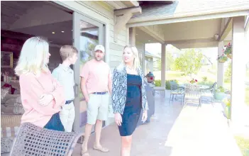  ??  ?? Charlotte Durham, a owner-broker for Big Sky Sotheby’s Internatio­nal Realty, shows clients a listing in Bozeman in the Black Bull community, a private golf course a few miles west of downtown.