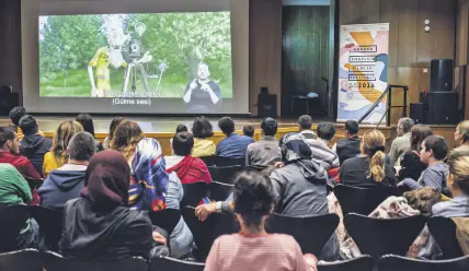  ??  ?? Within the scope of the autism-friendly screening, children watch movies in a dim hall with the sound lowered. No promotiona­l movies or advertisem­ents are included in the screenings.